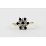 A 9ct yellow gold diamond and sapphire set cluster ring, (L).