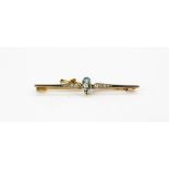 An yellow and white metal (tested 18ct gold) brooch set with an aquamarine and diamonds, L. 6cm.