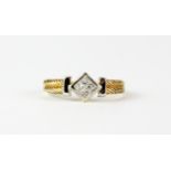 A 9ct yellow and white gold ring set with four princess cut diamonds, (Q).