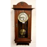 A 1930's oak wall clock, H. 85cm.
