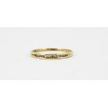 A 9ct yellow gold diamond set half eternity ring, (N.5).