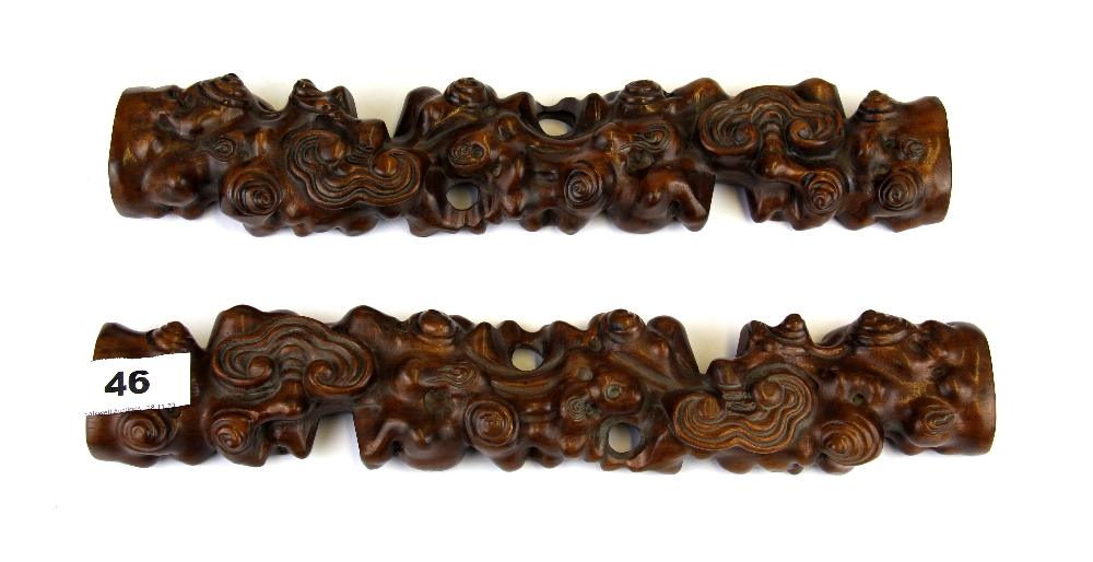 A pair of Chinese carved wooden scroll weights, L. 33cm.