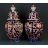 A pair of 19th Century Japanese Imari porcelain jars and covers, H. 33cm.