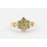 An 18ct yellow gold cluster ring set with a brilliant cut fancy yellow diamond and further diamonds,