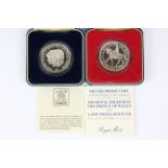 Two boxed silver proof commemorative coins.