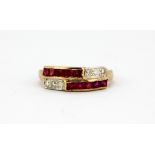 A yellow metal (tested minimum 9ct gold) ring set with step cut rubies and brilliant cut