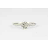 A 9ct white gold diamond set cluster ring, (M).