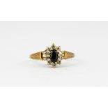 A 9ct yellow gold sapphire and white stone set cluster ring, (M).