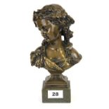 A bronze bust of a lady on a hardstone pedestal, H. 21cm.