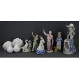 Five Lladro figurines and two Nao figurines, tallest H. 27cm.