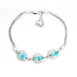 A 925 silver bracelet set with oval cut blue topaz and white stones, L. 17cm.