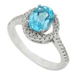 A 925 silver halo ring set with an oval cut blue topaz and white stones, (L).