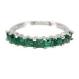 A 925 silver ring set with step cut emeralds, (L).