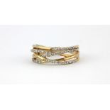 A 9ct yellow gold diamond set crossover ring, (O).