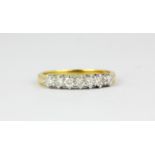 An 18ct white gold brilliant cut diamond set half eternity ring, approx. 0.50ct, (L).