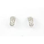 A pair of 9ct white gold diamond set earrings, L. 1.2cm.