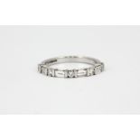 An 18ct white gold ring set with baguette and brilliant cut diamonds, (M).