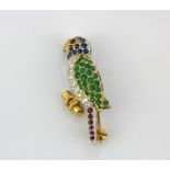 An 18ct yellow and white gold parrot shaped brooch set with rubies, emeralds, sapphires and