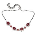 A 925 silver adjustable bracelet set with cabochon cut rubies.