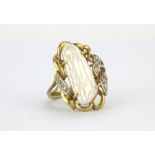 A 9ct yellow gold ring set with a baroque pearl and diamonds, (N.5).