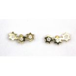 A pair of 9ct yellow gold stone set triple star shaped earrings, L. 1cm.