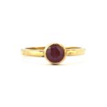 A 9ct yellow gold ruby set solitaire ring, (L).