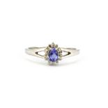 A 9ct white gold pear cut tanzanite and diamond set cluster ring, (N.5).