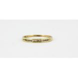 A 9ct yellow gold diamond set half eternity ring, (N.5).