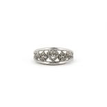 A 9ct white gold (stamped 10k) diamond set hearts ring, (M).