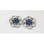 A pair of 9ct white gold sapphire set flower shaped earrings, Dia. 2cm.