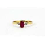 A 9ct yellow gold ring set with an oval cut ruby and brilliant cut diamond set shoulders, (N).