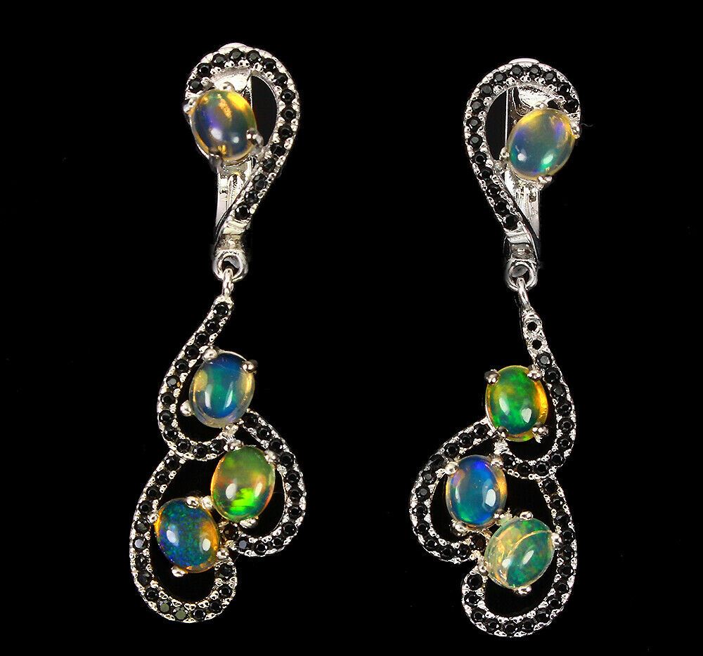 A pair of 925 silver drop earrings set with opals and black spinels, L. 30.4cm.