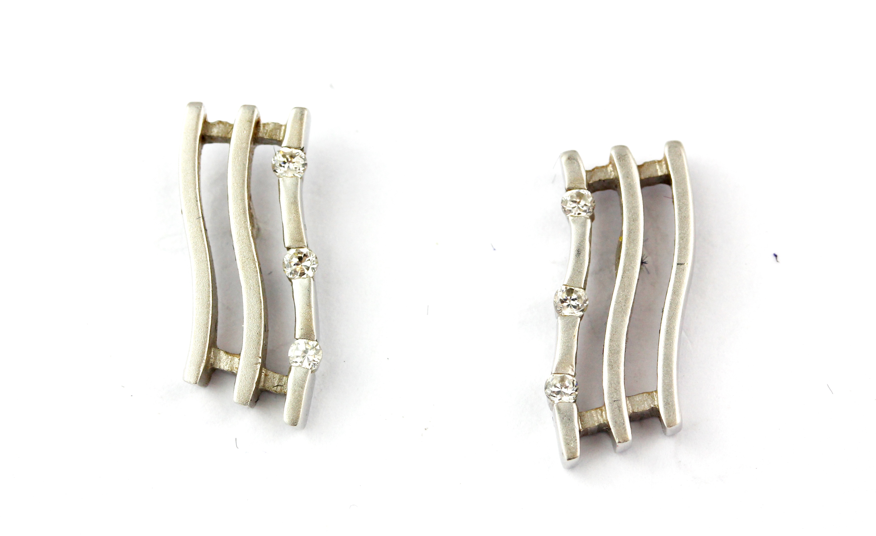 A pair of 18ct white gold diamond set triple wave earrings, L. 1.5cm.