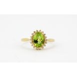 A 9ct yellow gold oval cut peridot and rose cut diamond set cluster ring, (M).