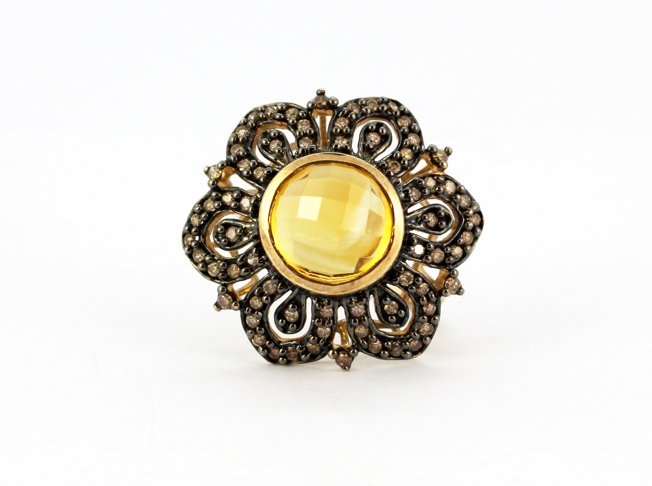 A 9ct yellow gold flower shaped ring set with a faceted cut citrine and brilliant cut fancy yellow