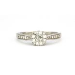 A 9ct white gold diamond set cluster ring, (P).