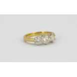 An 18ct yellow and white gold ring set with three brilliant cut diamonds, 1ct overall, (J.5).