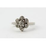 A 14ct white gold diamond set cluster ring, approx. 0.70ct overall, (N).