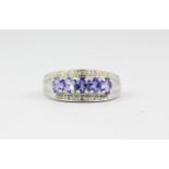 A 9ct white gold tanzanite and diamond set ring, (M).