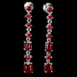 A pair of 925 silver drop earrings set with oval and round cut rubies, L. 4cm.