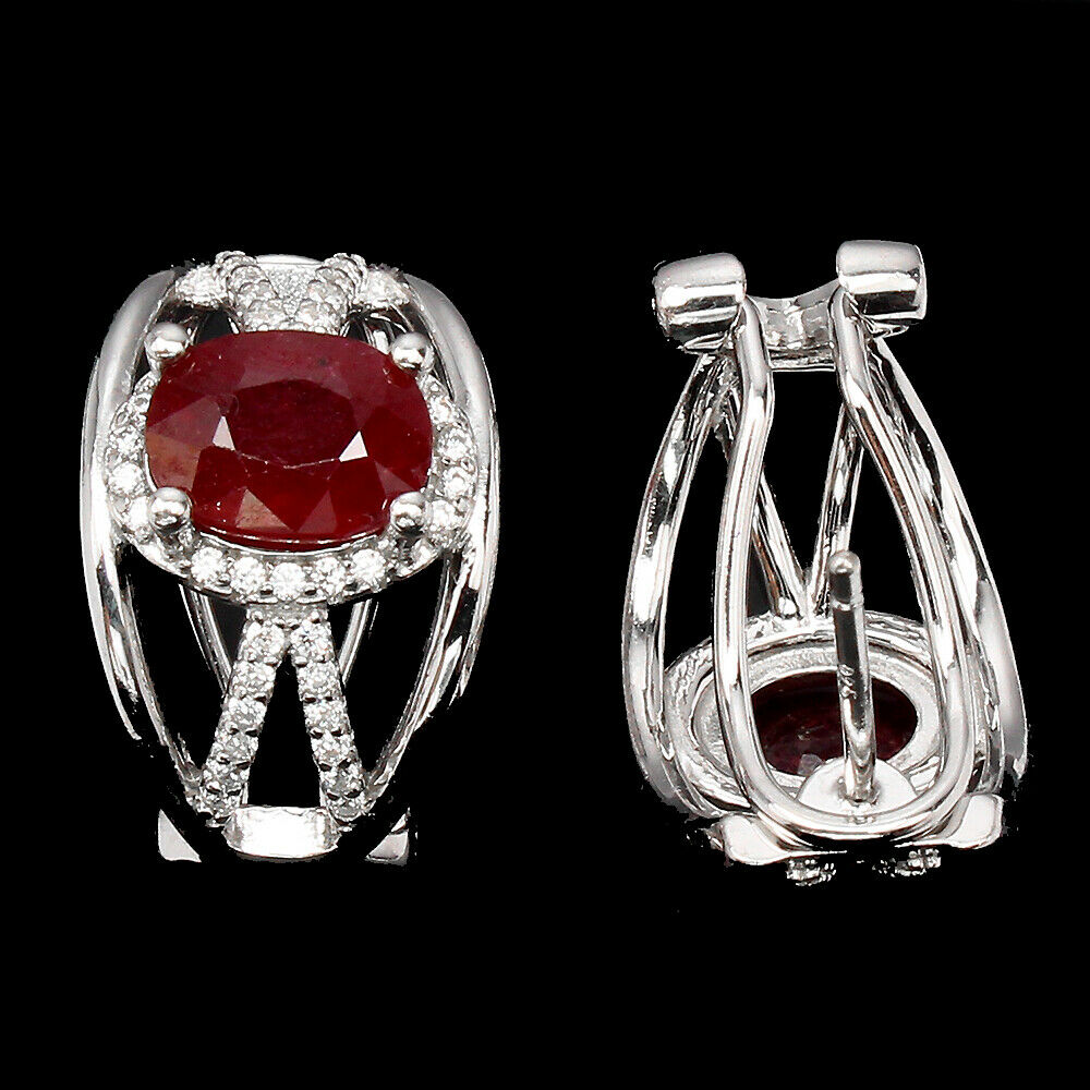 A pair of 925 silver earrings set with oval cut rubies and white stones, L. 1.6cm. - Image 2 of 2