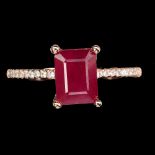 A 925 silver rose gold gilt ring set with a baguette cut ruby and white stone set shoulders, (N).