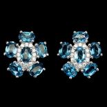 A pair of 925 silver flower shaped earrings set with London blue topaz and white stones, L. 1.8cm.