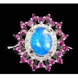 A 925 silver cluster ring set with a cabochon cut opal surrounded by rubies, (R.5).