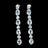 A pair of 925 silver drop earings with rub over set oval and round cut blue topaz, L. 5cm.