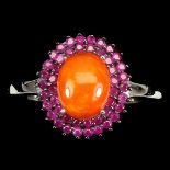 A 925 silver cluster ring set with rubies and a cabochon cut fire opal, (O.5).