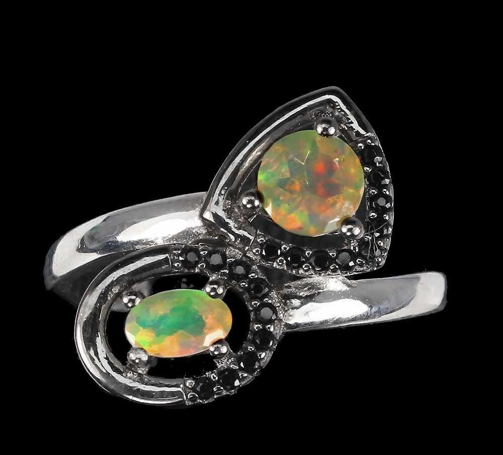 A 925 silver crossover ring set with opals and black spinels, (R).