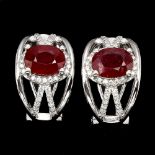 A pair of 925 silver earrings set with oval cut rubies and white stones, L. 1.6cm.