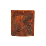 A Tibetan carved Yak bone amulet of a tiger on a rock, 5 x 5cm.