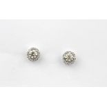 A pair of 18ct white gold (stamped 750) brilliant cut diamond set halo earrings, approx. 1ct